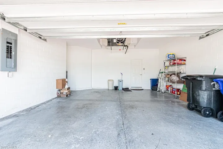 Garage with electric panel and concrete block wall