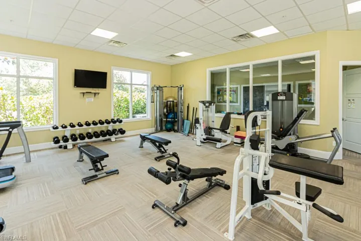 Gym with baseboards, carpet, and a paneled ceiling