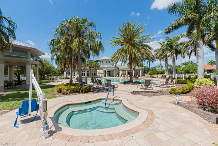 Community pool featuring a hot tub and a patio