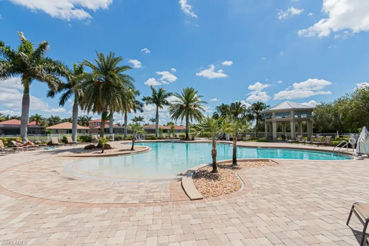 Community pool featuring a patio area, a gazebo, and fence