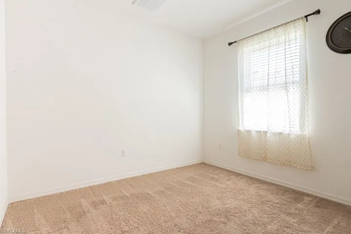 Master bedroom with carpet floors and baseboards