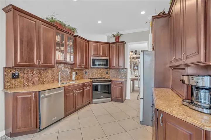 GOURMET KITCHEN WOOD CABINETRY AND SLEEK GRANITE COUNTERS