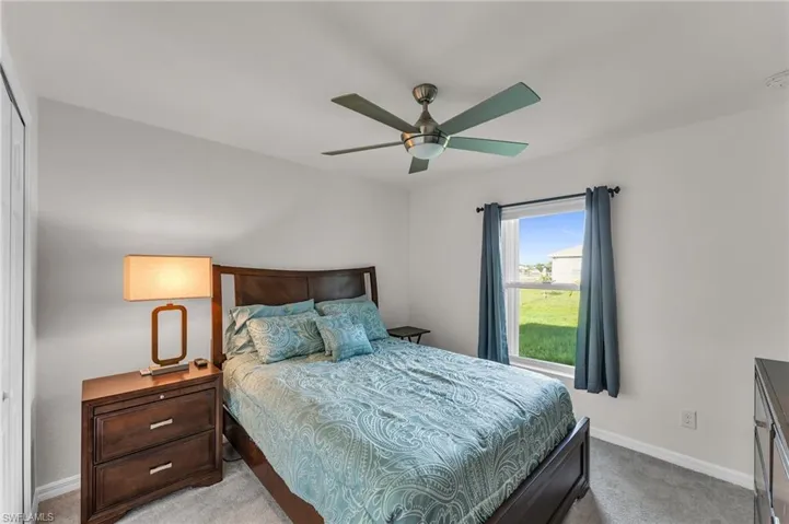 Carpeted bedroom with ceiling fan