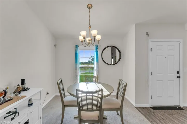 Dining room featuring light wood-type flooring and an inviting chandelier