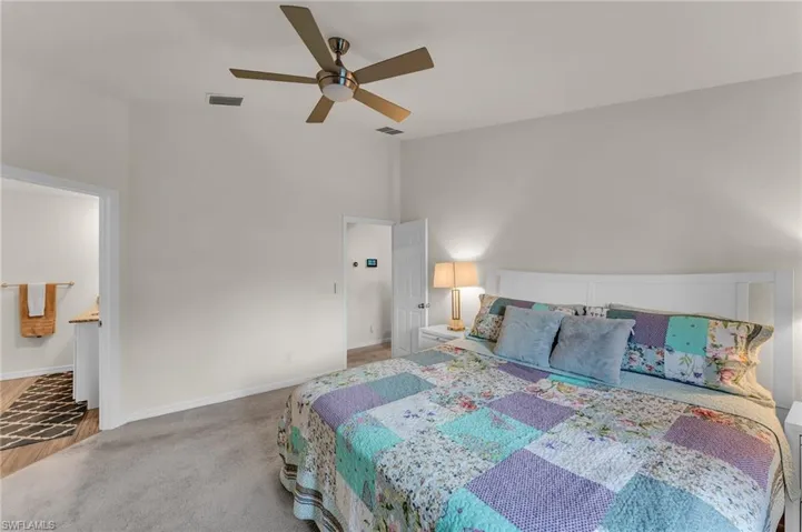 Bedroom with ceiling fan and carpet