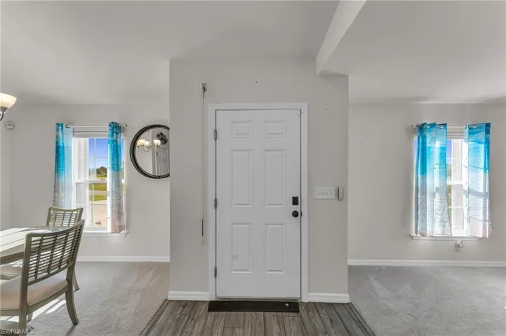 Entrance foyer with dark hardwood / wood-style floors