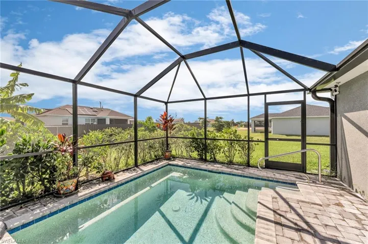 View of swimming pool with glass enclosure