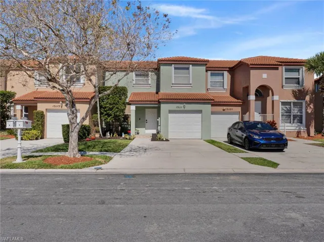 Mediterranean / spanish-style home with stucco siding, a tiled roof, driveway, and an attached garage