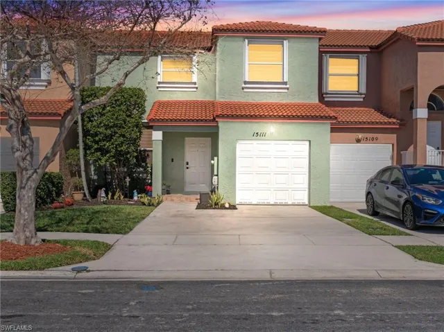 Mediterranean / spanish-style home with a tiled roof, stucco siding, concrete driveway, and an attached garage