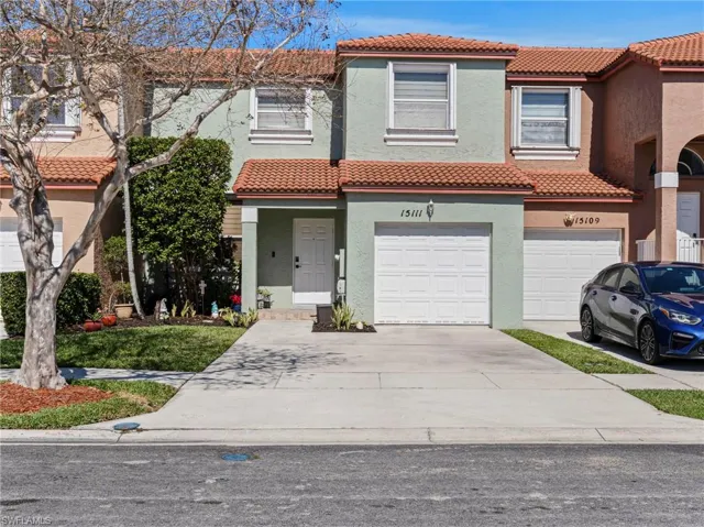 Mediterranean / spanish home with a tiled roof, stucco siding, an attached garage, and concrete driveway