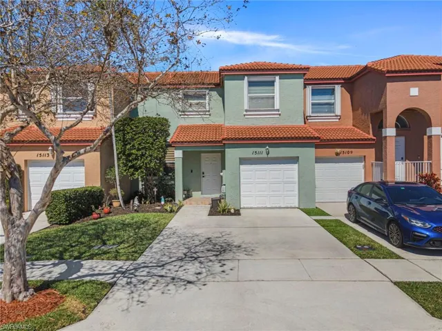 Mediterranean / spanish house with stucco siding, a tiled roof, concrete driveway, and an attached garage