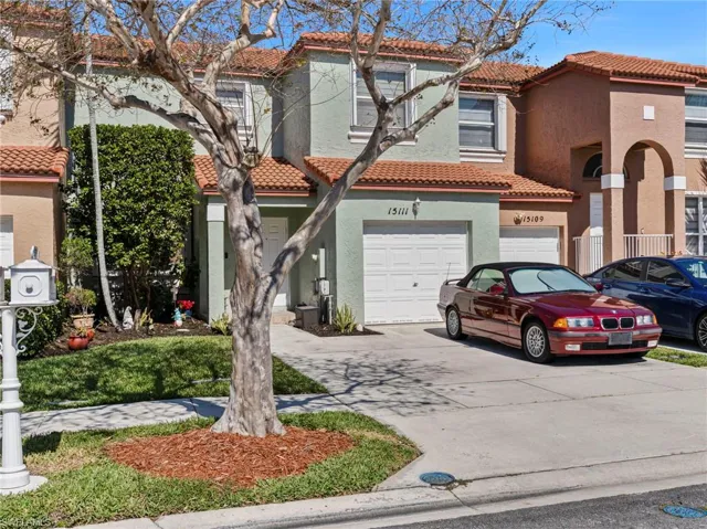 Mediterranean / spanish house featuring a tiled roof, stucco siding, driveway, and a garage