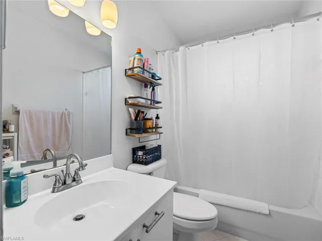 Full bathroom featuring vanity and shower / bath combo with shower curtain