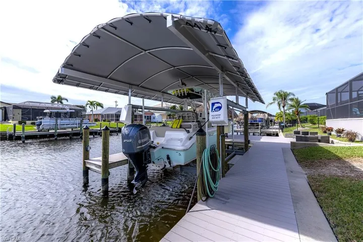 Large dock area with boat lift and covering