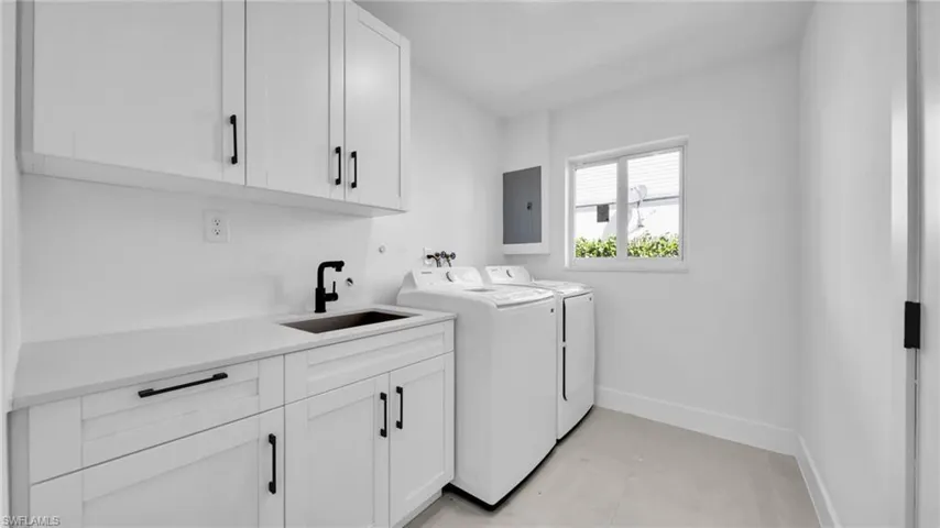 Laundry area featuring cabinet space and washer and clothes dryer