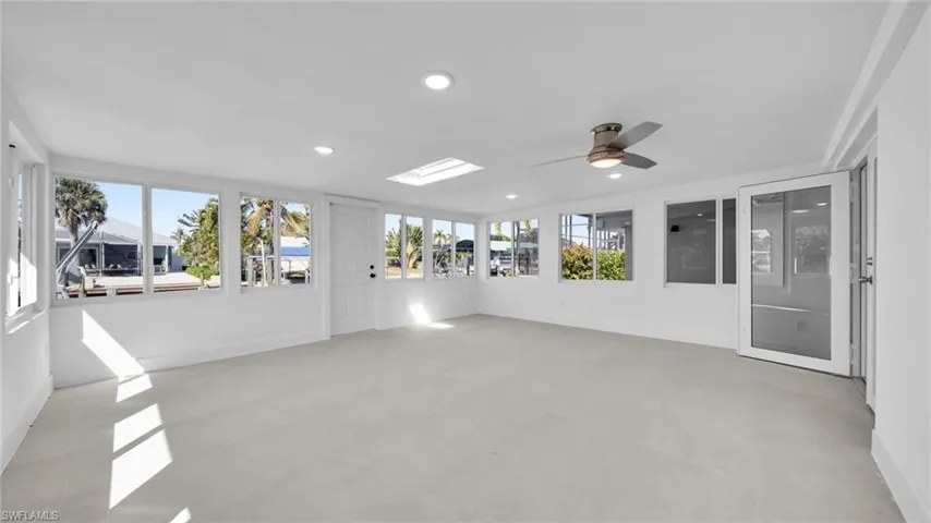 Unfurnished sunroom with a skylight and recessed lighting