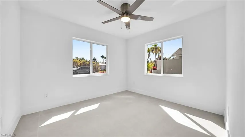 Spare room with baseboards and a ceiling fan