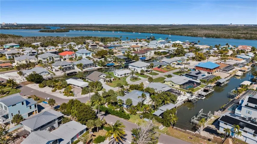 Aerial view of property and surrounding area featuring nearby suburban area