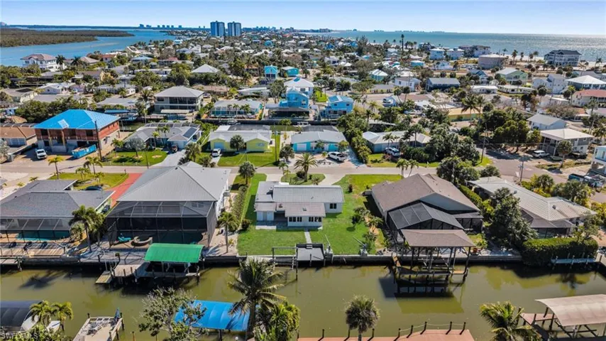 Aerial perspective of suburban area with a large body of water