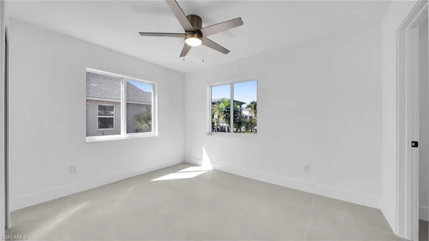 Spare room with a ceiling fan and baseboards