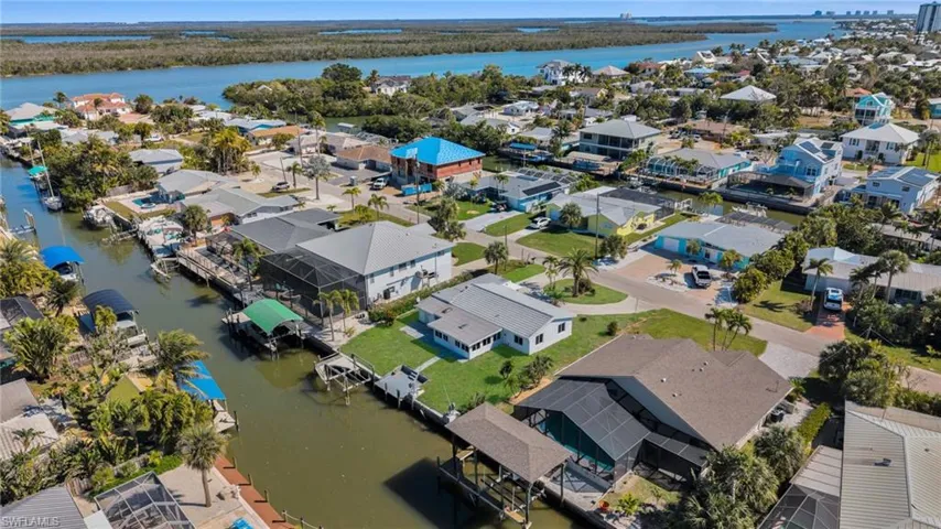 Aerial view of residential area featuring a nearby body of water