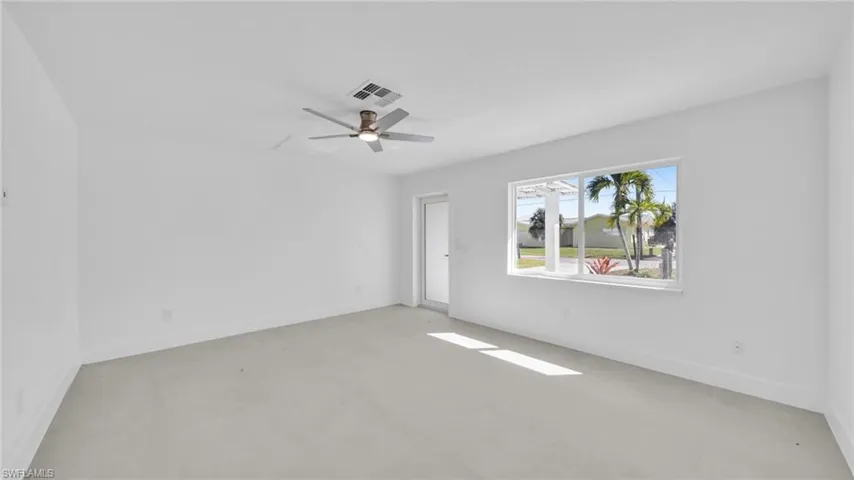 Empty room with a ceiling fan and concrete floors