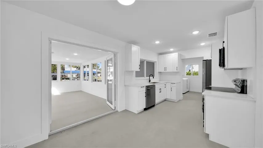 Kitchen with white cabinetry, light countertops, recessed lighting, finished concrete flooring, and stainless steel appliances