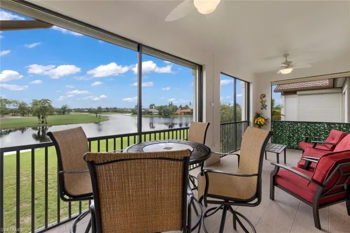 Sunroom / solarium with a water view and ceiling fan