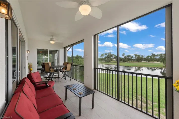 Sunroom with a water view and ceiling fan