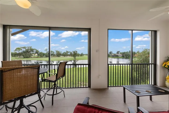 Sunroom featuring a water view and ceiling fan