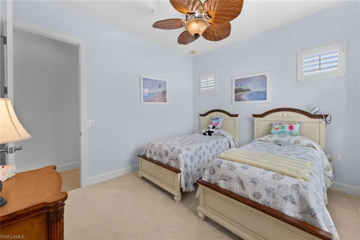 Bedroom featuring light carpet and ceiling fan