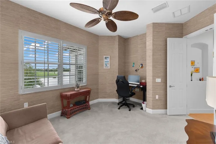 Carpeted office with ceiling fan