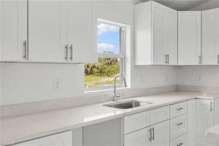 Kitchen featuring white cabinetry and plenty of natural light