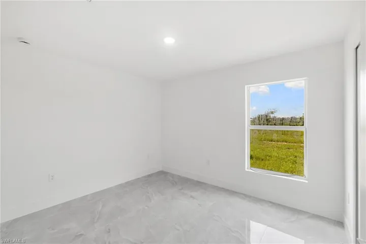 Unfurnished room featuring light marble finish floors and recessed lighting