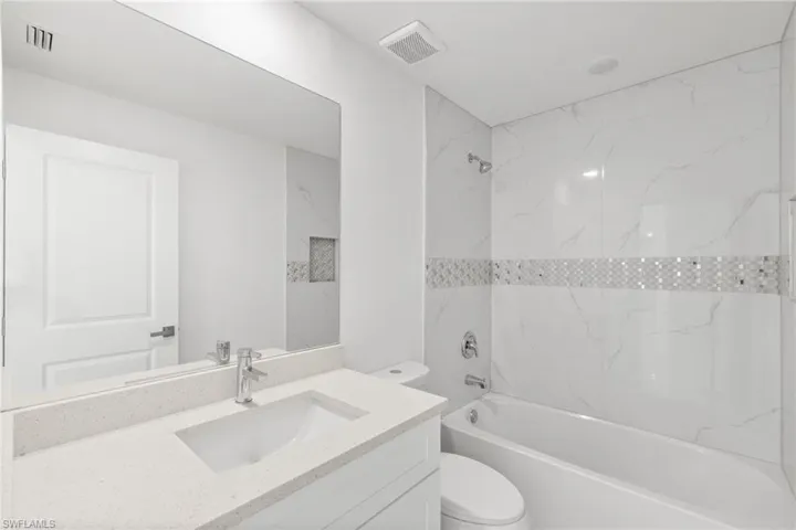 Full bath featuring vanity and bathing tub / shower combination