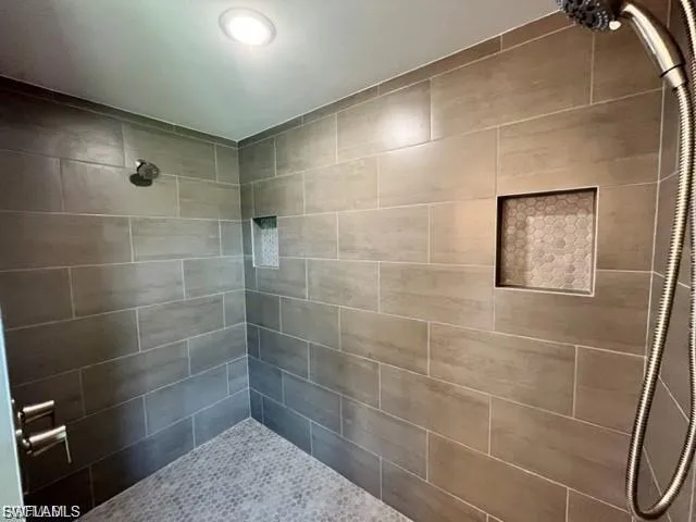 Bathroom featuring a tile shower