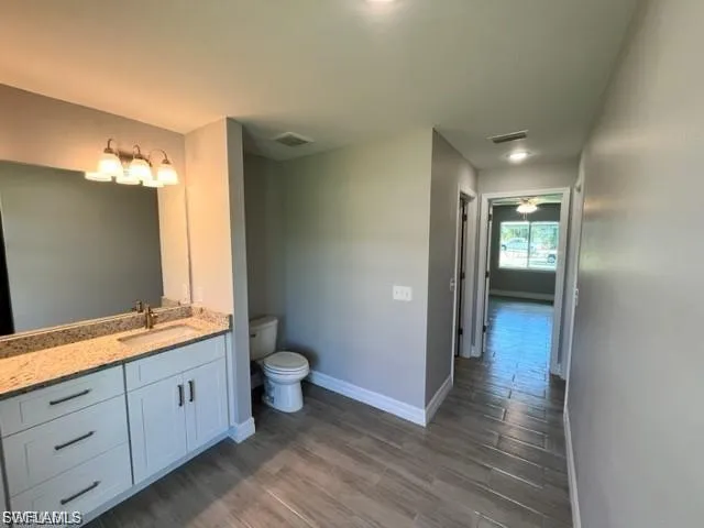 Bathroom featuring dark wood finished floors and vanity