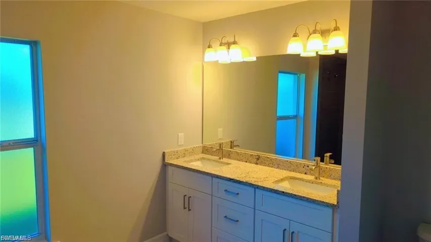 Bathroom with double vanity and a shower