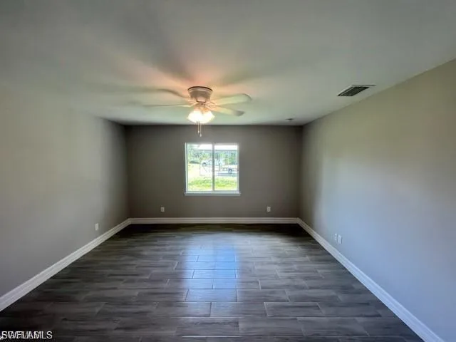 Empty room featuring wood tiled floors and a ceiling fan