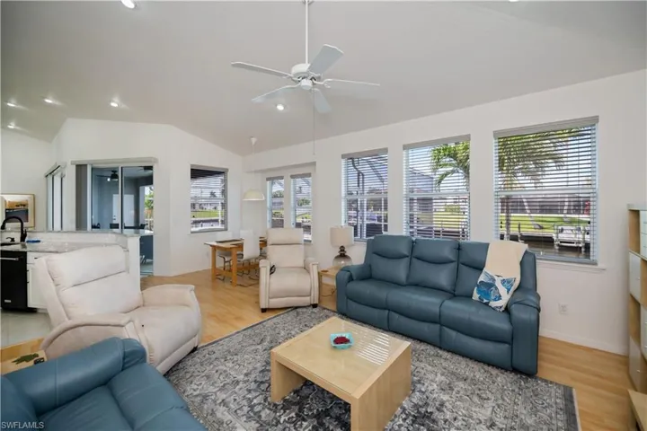 Family room featuring a ceiling fan, lofted ceiling, light wood-style flooring, and recessed lighting