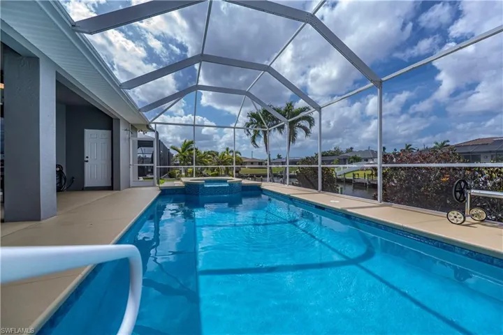 View of swimming pool with a lanai, a patio area, and a pool with connected hot tub