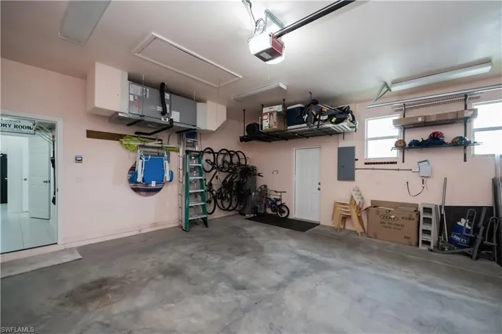 Garage featuring electric panel and a garage door opener