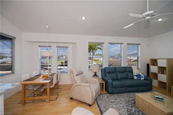 Living area with light wood-style flooring, baseboards, a ceiling fan, and recessed lighting
