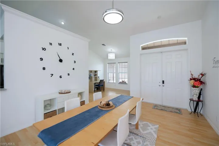 Living room or dining area featuring light wood-style flooring and baseboards