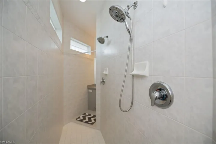 Full bath with a tile walk through shower