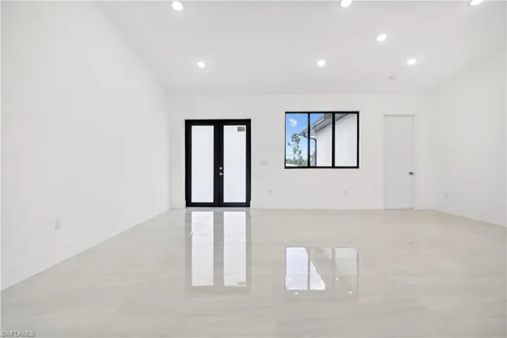 Spare room with french doors and light tile flooring