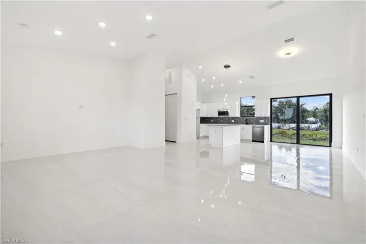 Unfurnished living room featuring light tile floors