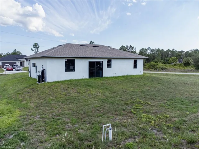 Back of property featuring a yard