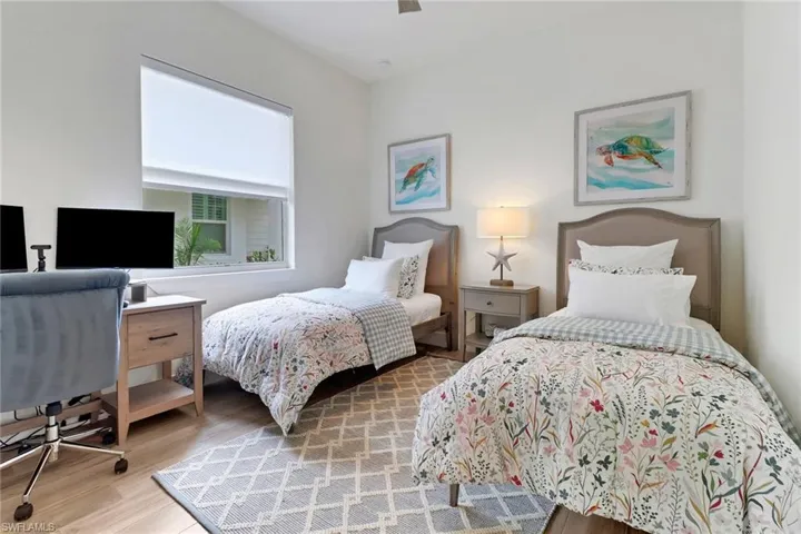 Bedroom with ceiling fan and wood-type flooring