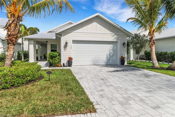 View of front of property with a garage and a front yard